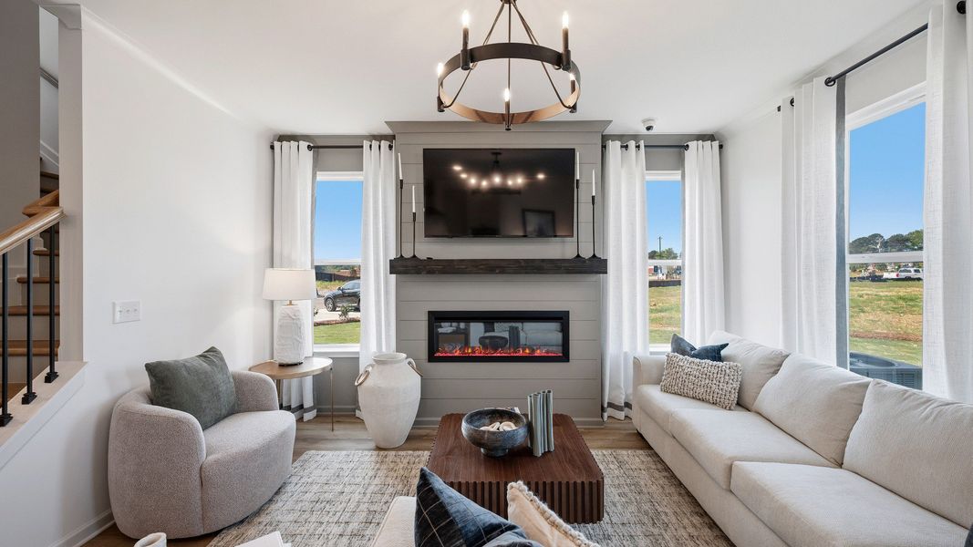Inviting family room with open concept design and abundant daylight in new construction townhome in Loganville, GA. Inviting family room with open concept design and abundant daylight in new construction townhome in Loganville, GA.