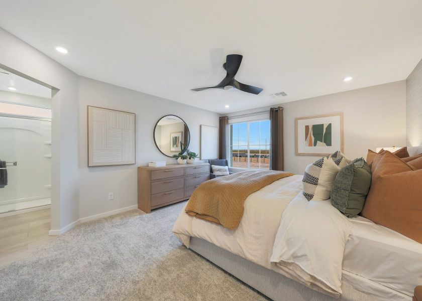 A bedroom with a bed and a fan. A bedroom with a bed and a fan.