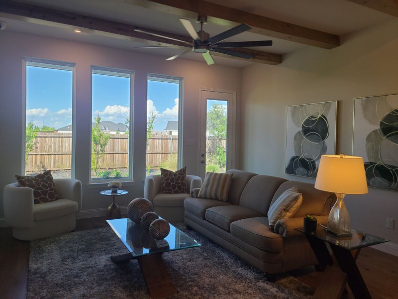 A cozy living room with modern furniture, large windows, and elegant decor.