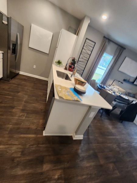 A modern kitchen featuring hardwood floors, sleek appliances, and a central island for casual dining. A modern kitchen featuring hardwood floors, sleek appliances, and a central island for casual dining.