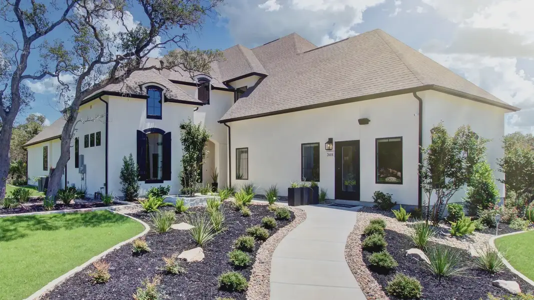 This Verandas at the Rim home features exquisite dormer windows and elegant landscaping, offering unmatched luxury.