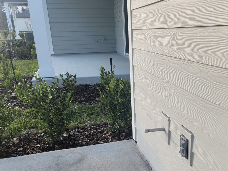 A charming exterior view with landscaped garden in Jennings Farm by LGI Homes (Middleburg, FL).