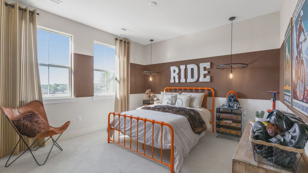 Elegant Dillon Pointe bedroom showcases unique orange metal bed and cyclist-themed decor. Elegant Dillon Pointe bedroom showcases unique orange metal bed and cyclist-themed decor.