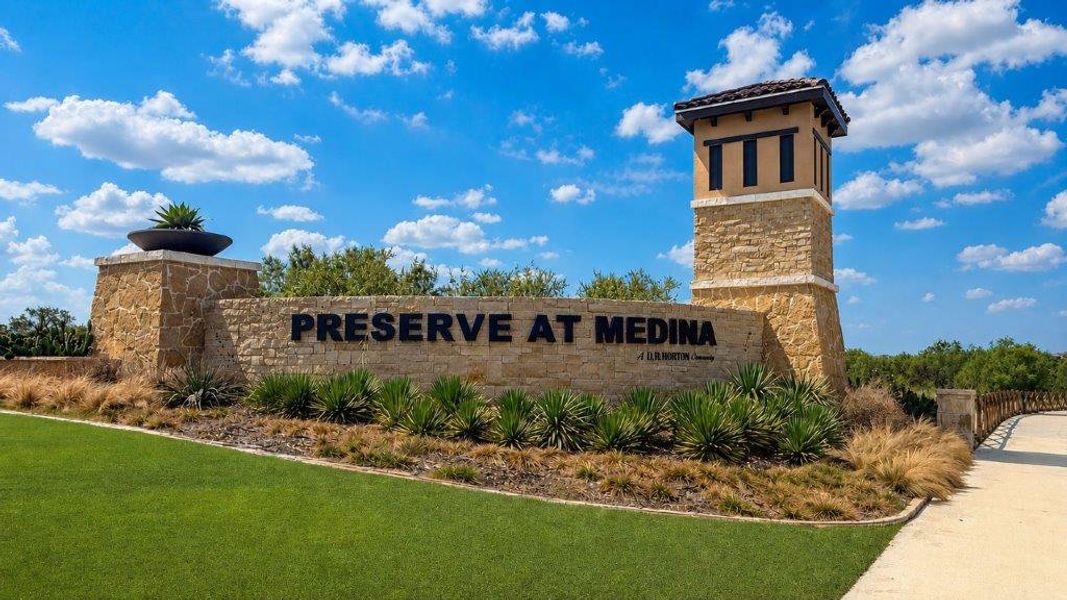 Entrance to the Preserve at Medina community in Von Ormy, TX, featuring signage and landscaping (Image 1). Entrance to the Preserve at Medina community in Von Ormy, TX, featuring signage and landscaping (Image 1).