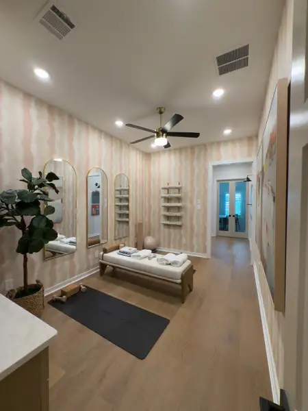 A chic workout space with elegant mirrors, a cozy bench, and wooden flooring creates a serene exercise environment. A chic workout space with elegant mirrors, a cozy bench, and wooden flooring creates a serene exercise environment.