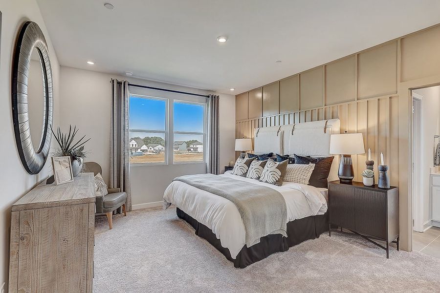 A bedroom with a large window. A bedroom with a large window.