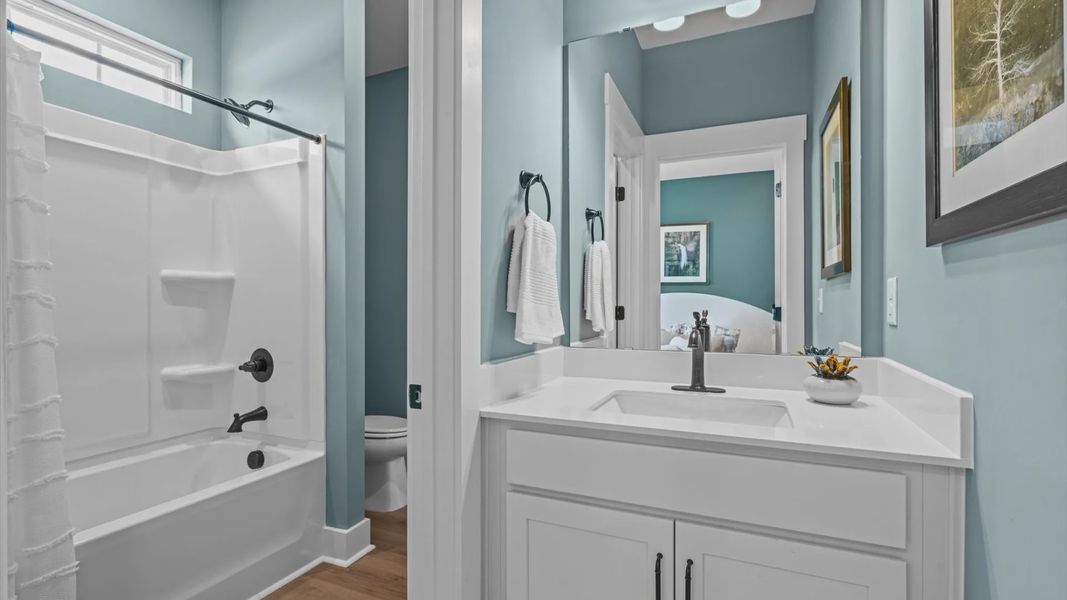 Secondary bathroom with two separate vanities and shared shower at Pinebrook by DRB Homes in Woodruff, SC Secondary bathroom with two separate vanities and shared shower at Pinebrook by DRB Homes in Woodruff, SC
