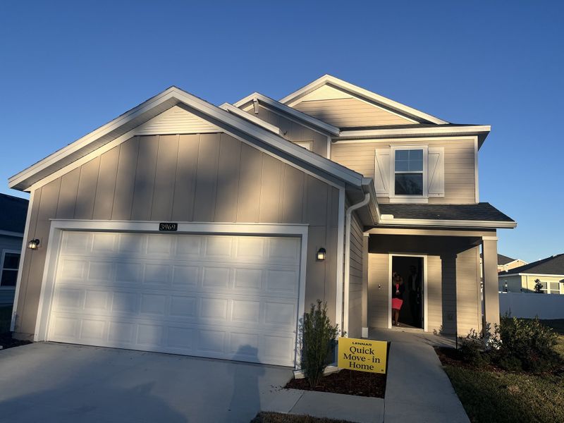 A modern two-story beige home with a spacious garage in Millwood Estates - The Meadows by Lennar (Ocala, FL).