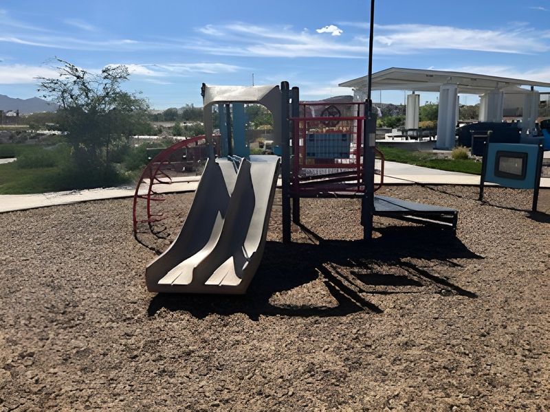 A vibrant playground with slides and climbing structures in Alamar: Premier by Lennar (Avondale, AZ).