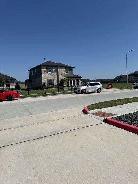 A charming brick home with a spacious yard in Newport Pointe by D.R. Horton (Crosby, TX).