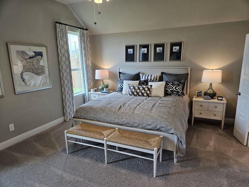 A cozy bedroom with elegant decor, featuring plush bedding, framed artwork, and soft carpeting for ultimate comfort. A cozy bedroom with elegant decor, featuring plush bedding, framed artwork, and soft carpeting for ultimate comfort.