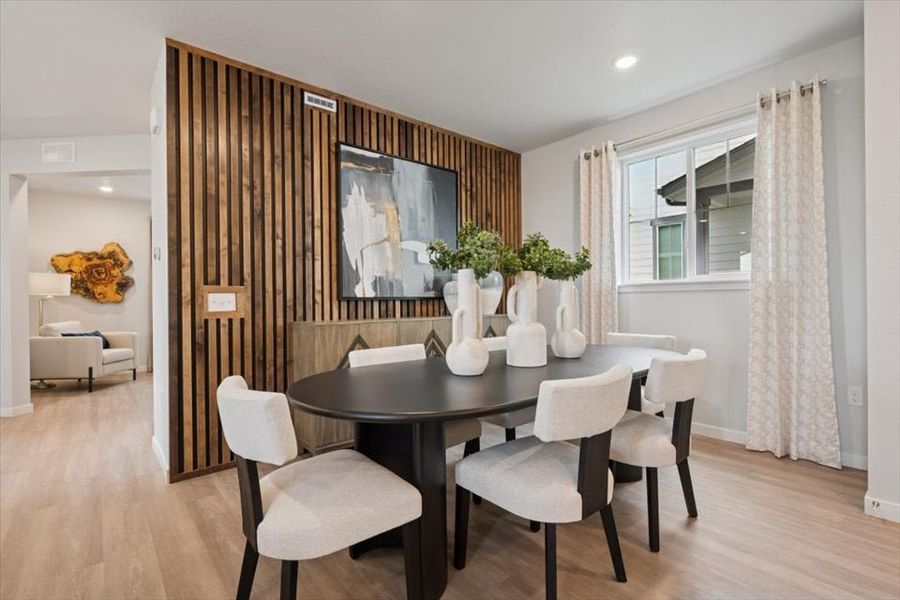 A room with a table and chairs.