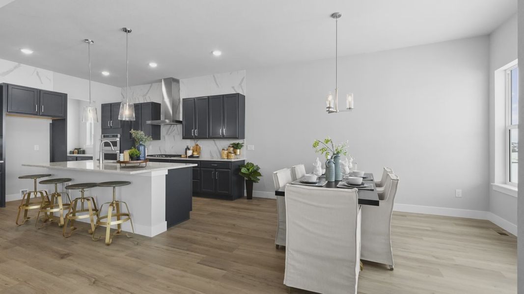 Luxurious Montaine kitchen boasts marble backsplash and crisp cabinetry, creating a serene culinary space.