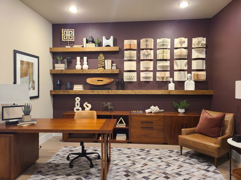 A sophisticated home office with rich wood furniture, decorative shelves, and geometric wall art. A sophisticated home office with rich wood furniture, decorative shelves, and geometric wall art.