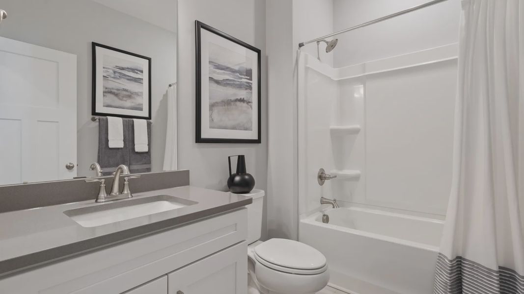 Secondary bathroom with polished nickel hardware and gray accents at DRB Homes' Walnut Ridge in Inman, SC