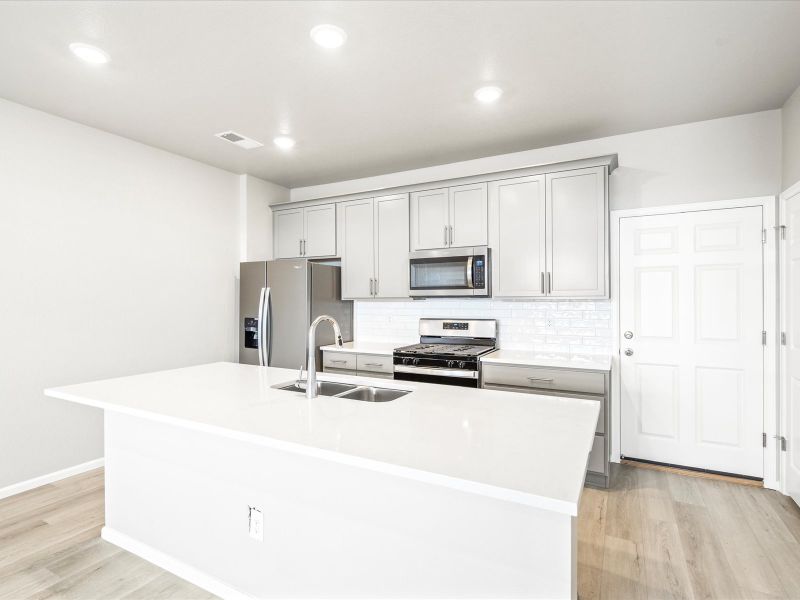 Kitchen in the Orchard floorplan at a Meritage Homes community in Aurora, CO.