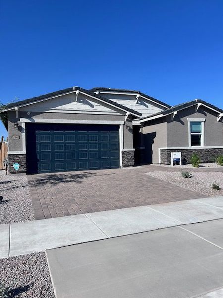 A modern gray home with a blue garage and xeriscaped yard in Silva Farms by Meritage Homes (Goodyear, AZ). A modern gray home with a blue garage and xeriscaped yard in Silva Farms by Meritage Homes (Goodyear, AZ).