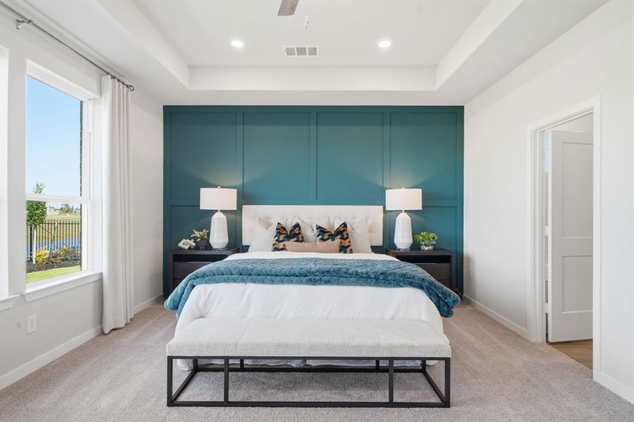 A bedroom with a bed and a table.