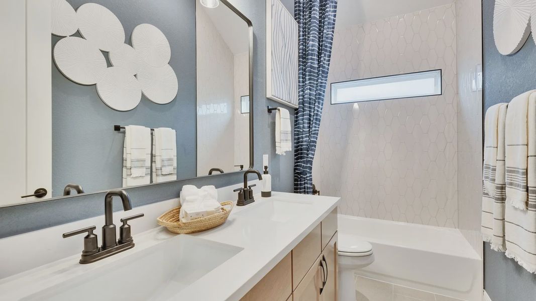 Elegantly designed bathroom with hexagonal tiles and sophisticated double vanity in Spring Creek.