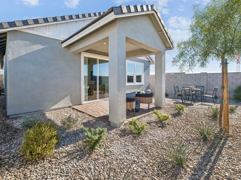 A house with a patio and a tree.