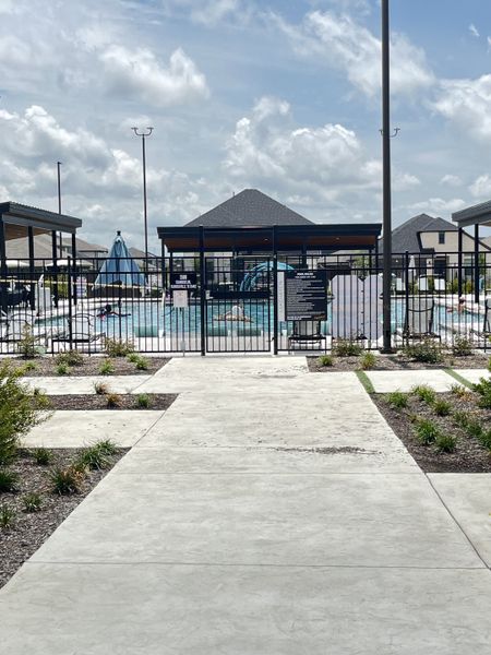 A welcoming community pool area with shaded seating in Lakehaven by Trophy Signature Homes (Farmersville, TX).