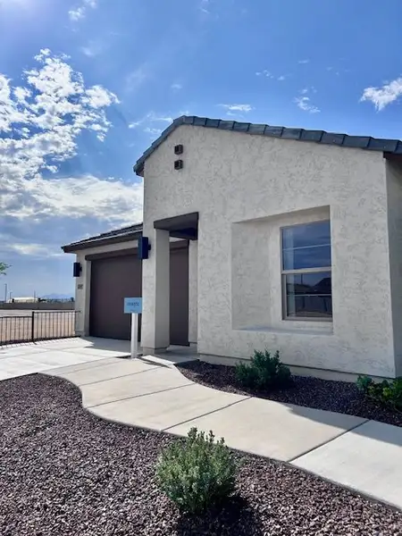 Charming stucco home with modern design in Monroe Ranch by K. Hovnanian® Homes, Buckeye, AZ.