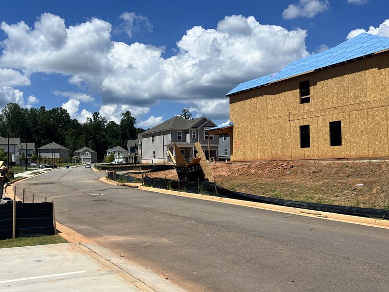 New homes under construction on a tranquil street in Millers Pointe by Lennar (Conyers, GA).