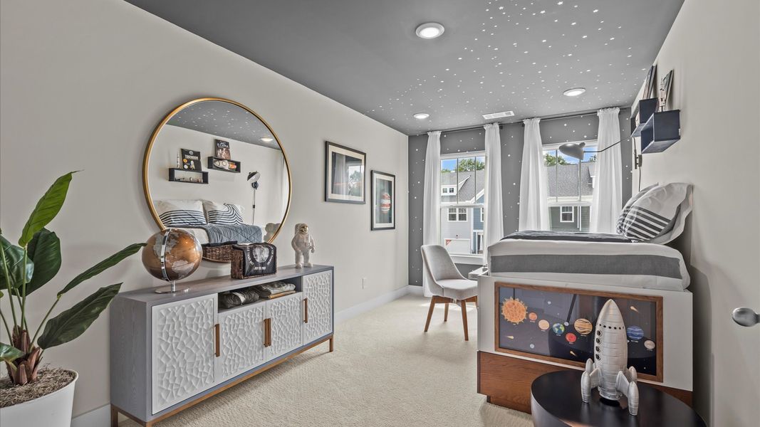 Plush carpeted secondary bedroom with large windows in two story townhome at Ransdell Pointe by DRB Homes in Spartanburg, SC
