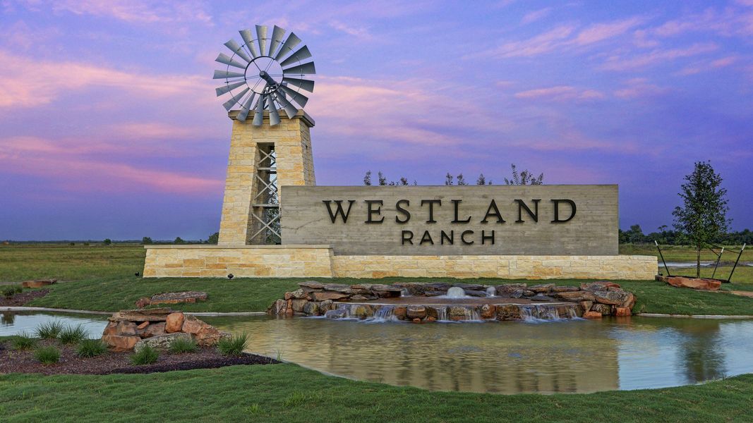 Dramatic stone entrance with striking windmill and serene pond. Westland Ranch, Texas. Dramatic stone entrance with striking windmill and serene pond. Westland Ranch, Texas.