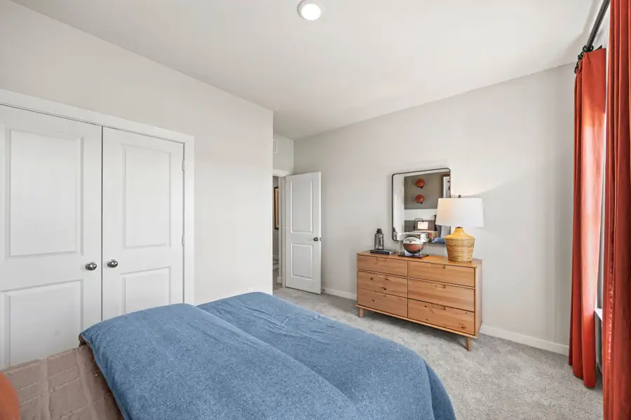 A bedroom with white doors.