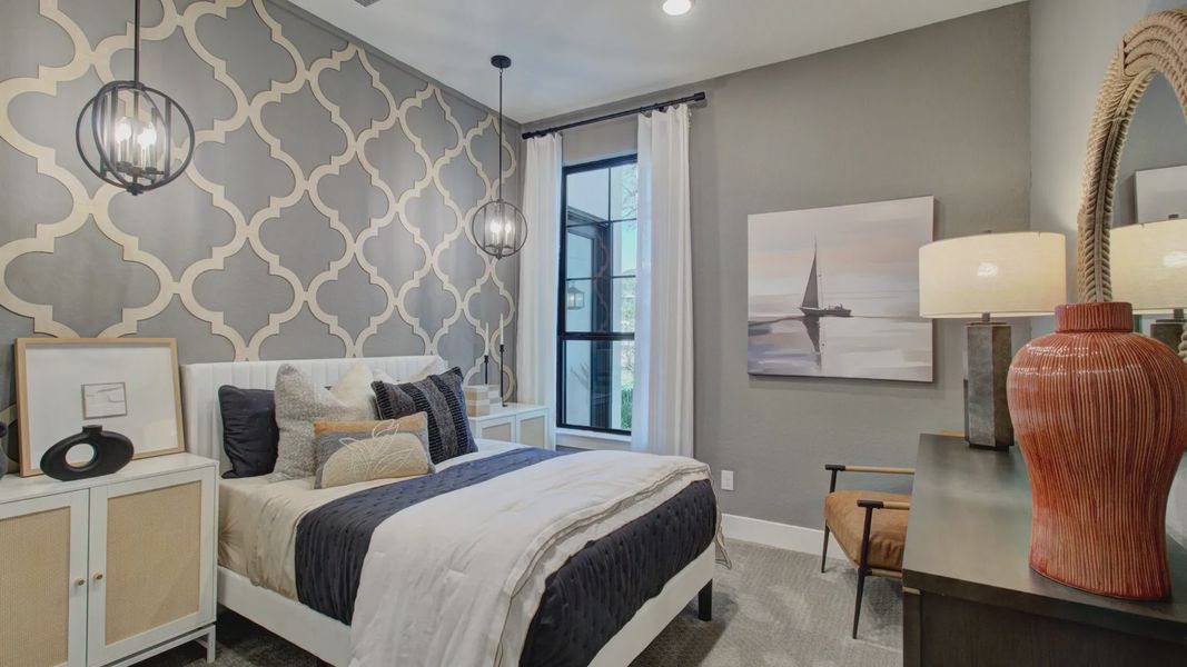 Sophisticated geometric wall and stylish pendant lighting define this exquisite Verandas at the Rim bedroom.