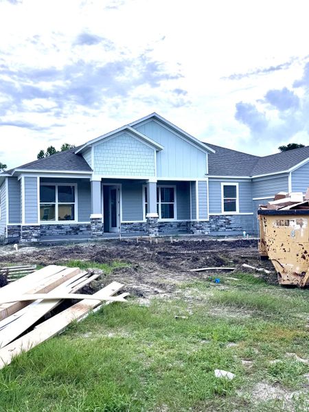 Charming blue home with stone accents in Jeremy’s Drive by Maronda Homes (Green Cove Springs, FL).