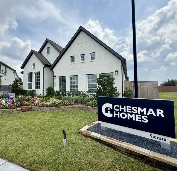 A charming white brick home with lush landscaping in Sienna by Chesmar Homes, Missouri City, TX. A charming white brick home with lush landscaping in Sienna by Chesmar Homes, Missouri City, TX.
