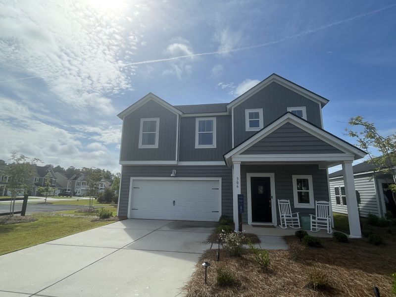 A charming gray home with a cozy porch in Cypress Preserve: American Dream Series by Lennar (Moncks Corner, SC).