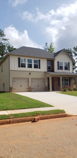 A charming two-story home with double garages and a manicured lawn in Twin Oaks by Dream Finders Homes (Villa Rica, GA). A charming two-story home with double garages and a manicured lawn in Twin Oaks by Dream Finders Homes (Villa Rica, GA).