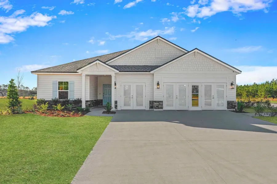 A white house with a driveway. A white house with a driveway.