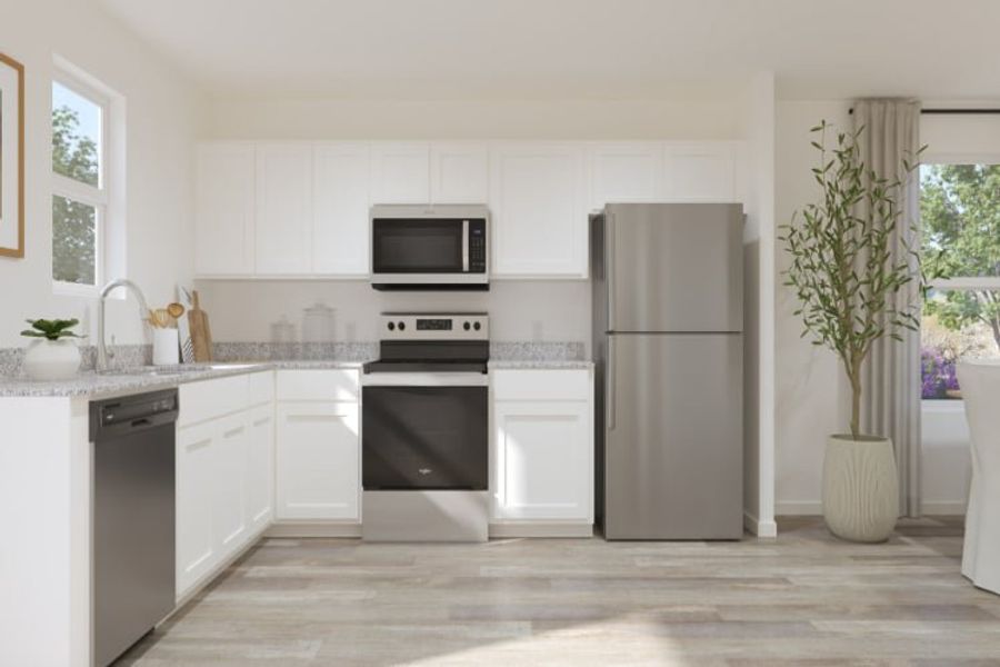 A kitchen with white cabinets.