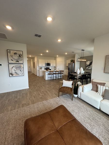 An inviting open-plan living space with cozy seating, hardwood floors, and modern kitchen amenities. An inviting open-plan living space with cozy seating, hardwood floors, and modern kitchen amenities.
