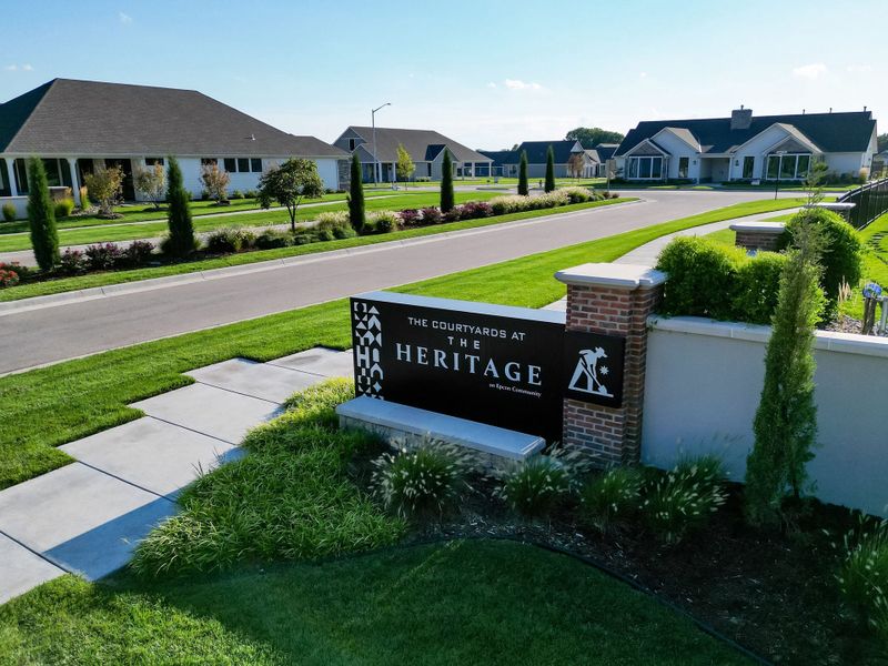 Entrance to the The Courtyards at The Heritage community in Andover, KS, featuring signage and landscaping (Image 30). Entrance to the The Courtyards at The Heritage community in Andover, KS, featuring signage and landscaping (Image 30).