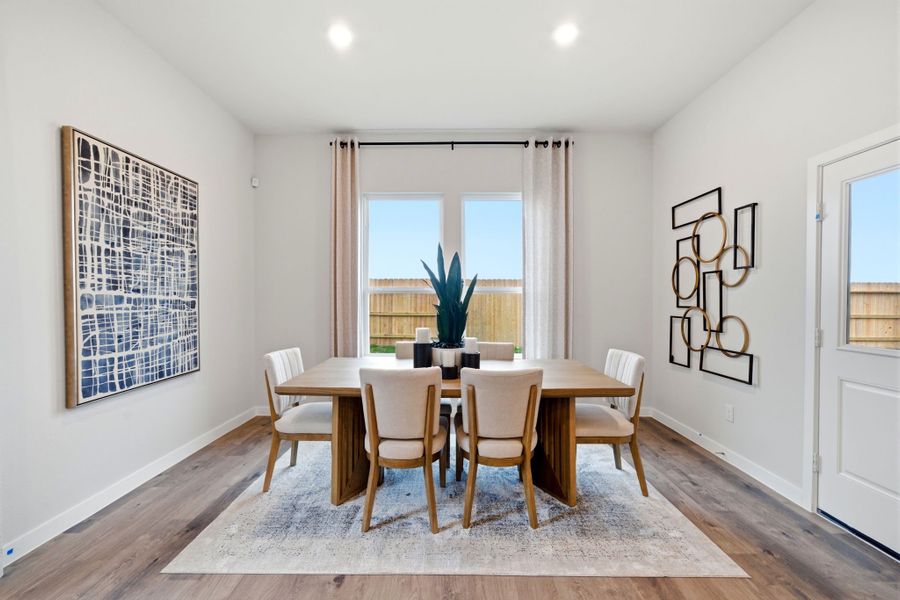 A dining room with a table and chairs. A dining room with a table and chairs.