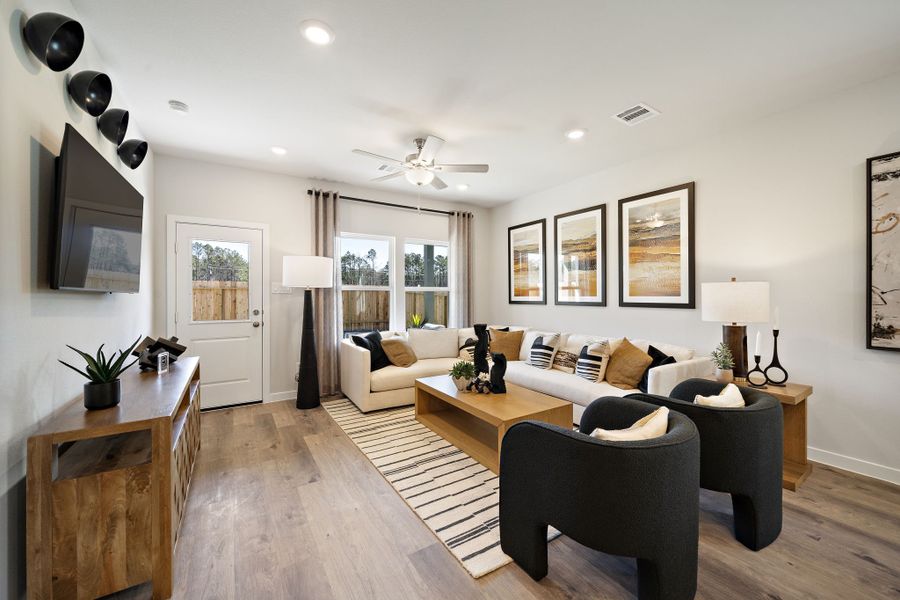 A living room with a wood floor.