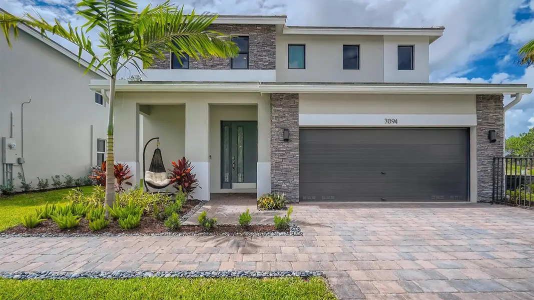 Front exterior of a home in the Reserve at Jupiter community, located in Jupiter, FL (Image 1). Front exterior of a home in the Reserve at Jupiter community, located in Jupiter, FL (Image 1).