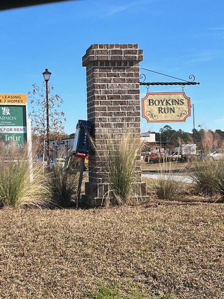 Welcome to Boykins Run Townhomes by DRB Homes in Moncks Corner, SC, showcasing a charming brick entrance with signage.
