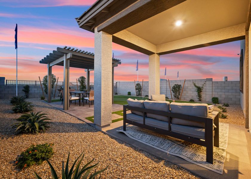 A couch and a table under a covered patio. A couch and a table under a covered patio.