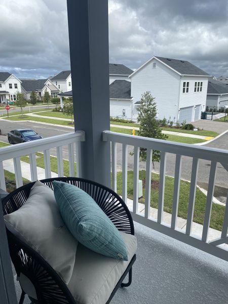 A cozy balcony with a view of a stylish neighborhood, featuring comfortable seating and vibrant outdoor greenery. A cozy balcony with a view of a stylish neighborhood, featuring comfortable seating and vibrant outdoor greenery.