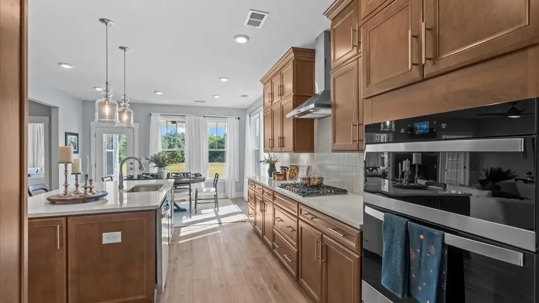 Well-designed kitchen with a center island and tasteful finishes that elevate everyday living by DRB Homes