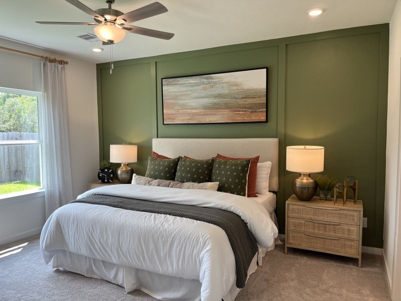 A cozy bedroom featuring a green accent wall, soft bedding, and stylish lighting for a relaxing atmosphere. A cozy bedroom featuring a green accent wall, soft bedding, and stylish lighting for a relaxing atmosphere.