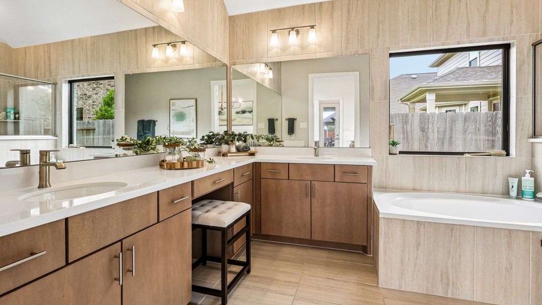 Experience refined elegance with light wood cabinetry and expansive mirrors in Sunterra's serene oasis. Experience refined elegance with light wood cabinetry and expansive mirrors in Sunterra's serene oasis.
