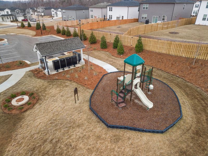 A miniature playground in a yard. A miniature playground in a yard.