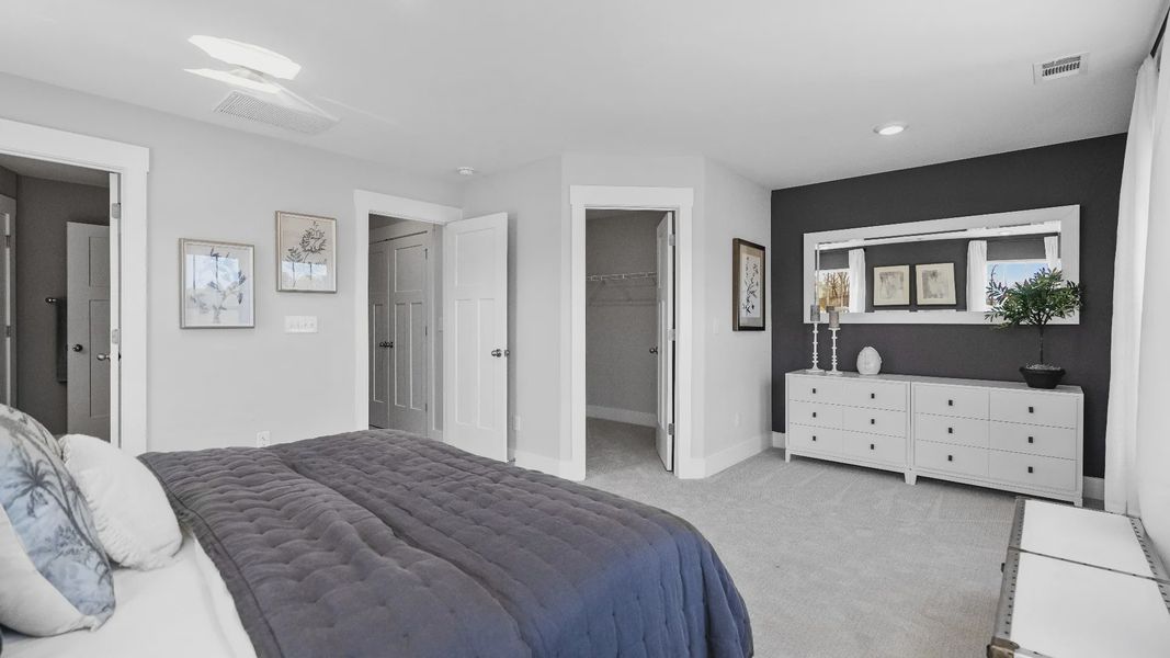 Cozy primary suite with large windows and plush carpets at Hickory Heights by DRB Homes near Downtown Greenville, SC